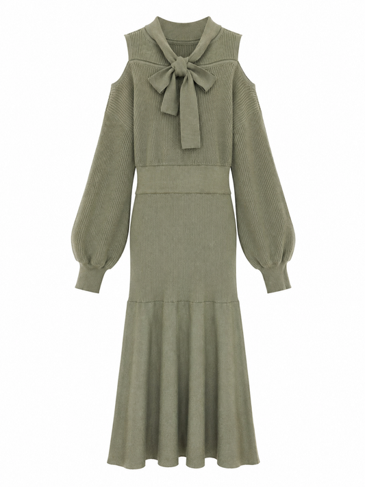 An olive green ribbed knit midi dress with a large bow at the collar, long balloon sleeves, and a tiered skirt, shown against a plain white background.