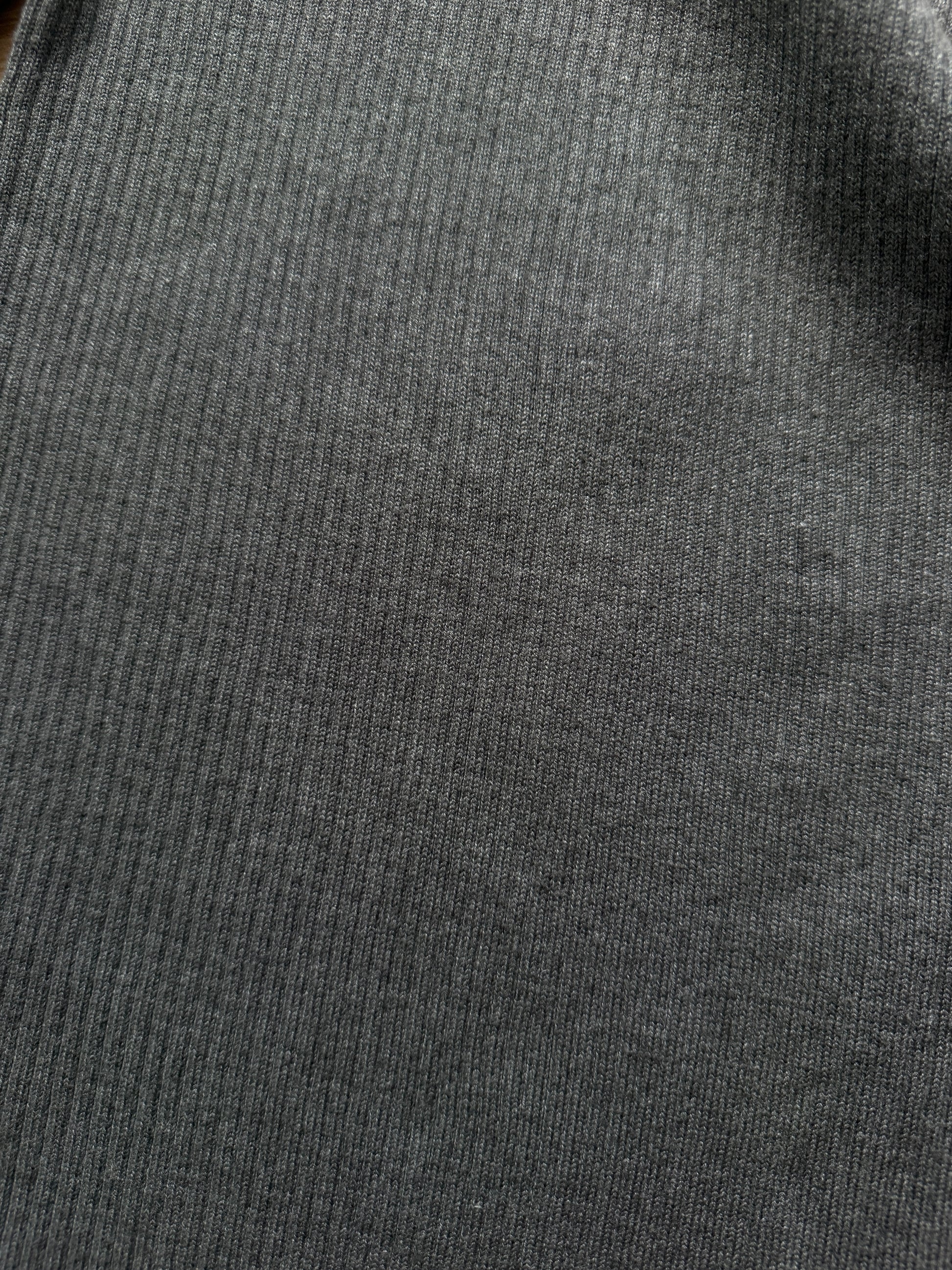 Close-up of a dark gray ribbed knit fabric texture.