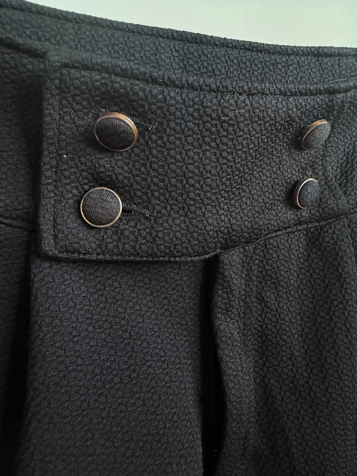 Close up picture of the buttons and fabric of INGNI Black High-Waisted Textured Shorts With Buttons