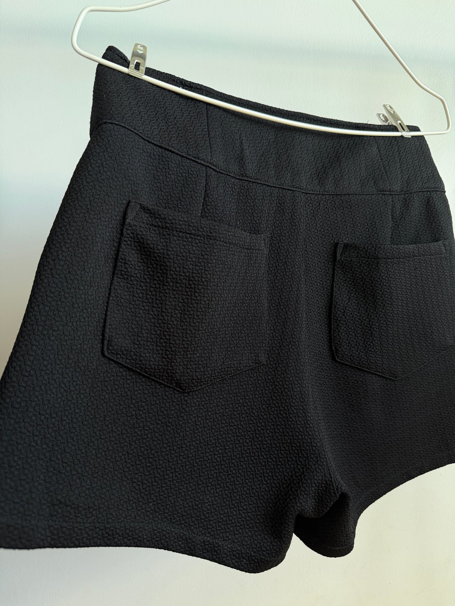 Back side picture of INGNI Black High-Waisted Textured Shorts With Buttons