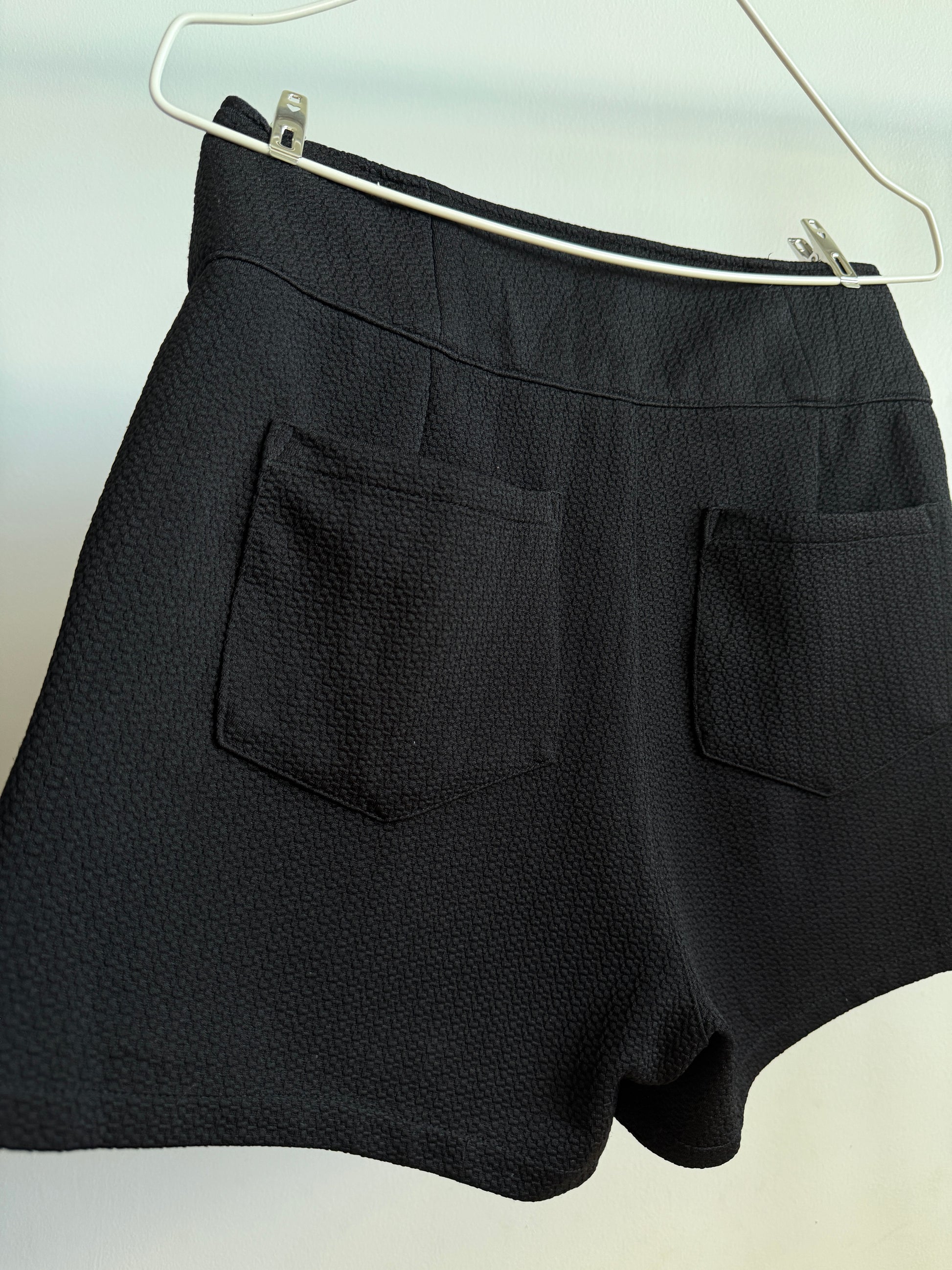 Back side picture of INGNI Black High-Waisted Textured Shorts With Buttons