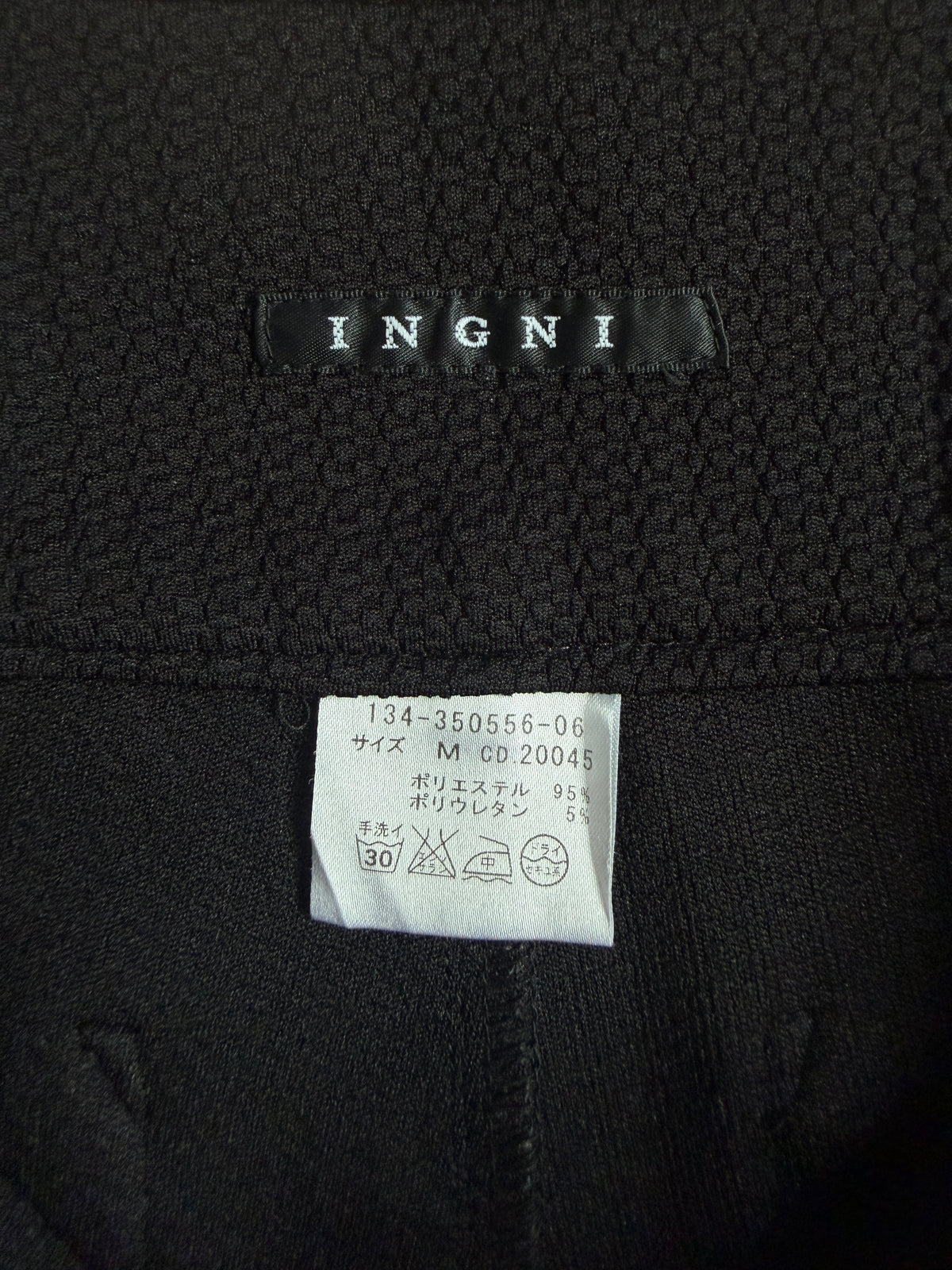 Tag saying "INGNI" and care tag of INGNI Black High-Waisted Textured Shorts With Buttons