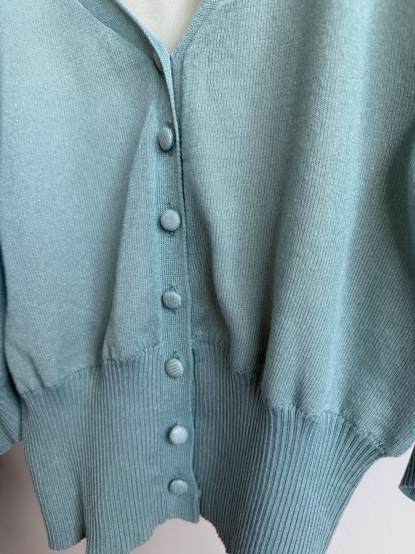 Close up picture of buttons of ROYAL PARTY Seafoam Blue Puff Sleeve Knit Cardigan 