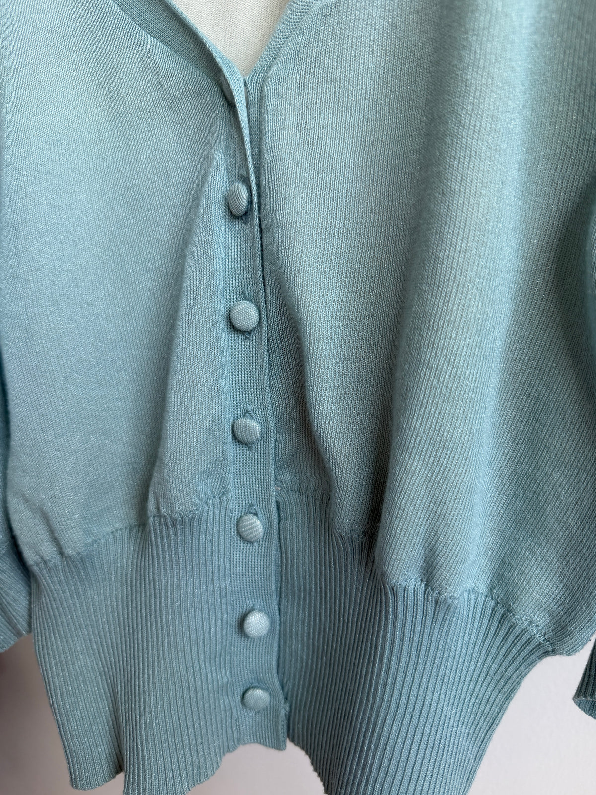 Close up picture of buttons of ROYAL PARTY Seafoam Blue Puff Sleeve Knit Cardigan 