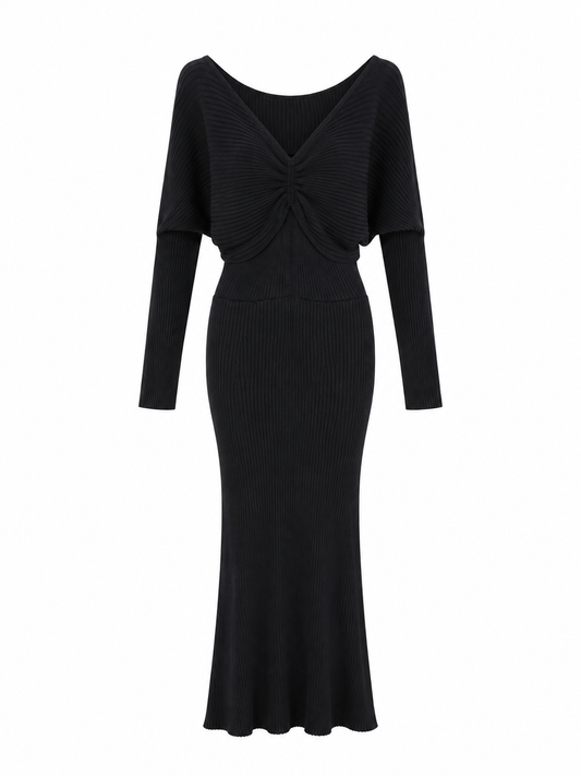 A black ribbed knit maxi dress with long sleeves, a wide boat neckline, and a gathered twisted detail at the bust, shown on a plain white background.